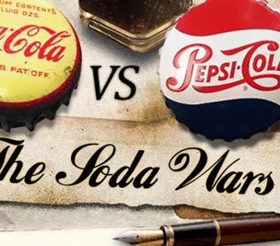 Coca-Cola and Pepsi Cola bottles lids representing the soda wars.
